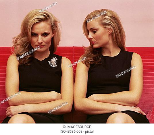 Woman looking jealously at another woman's brooch