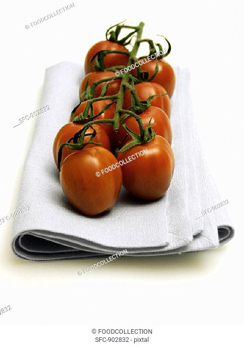 Vine Ripened Plum Tomatoes Resting on a Cloth