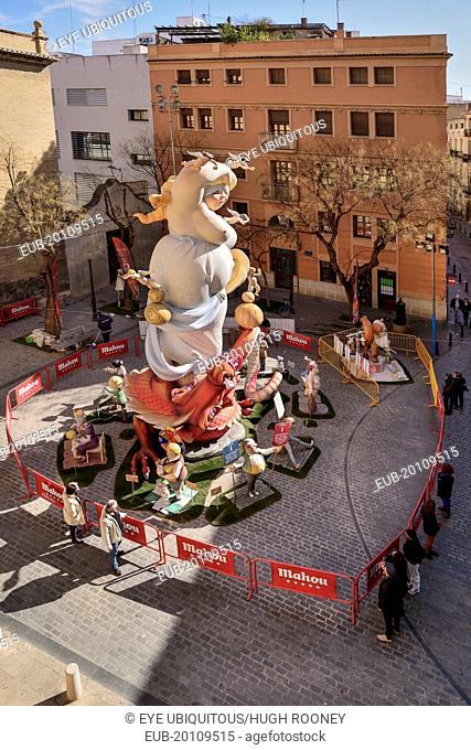 Papier Mache falla scene with onlookers viewing a giant figure of a lady in the street at Torres de Quart during Las Fallas festival