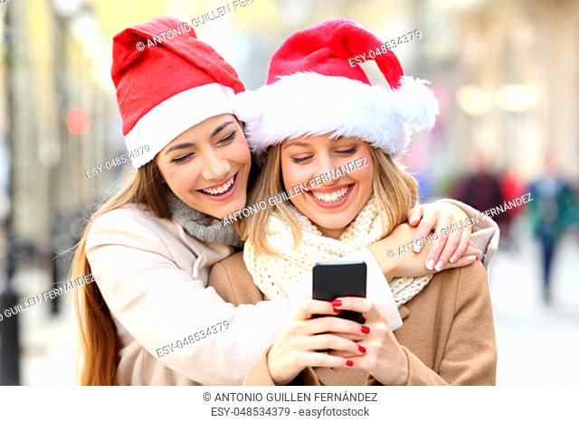 Friends texting on a phone on christmas