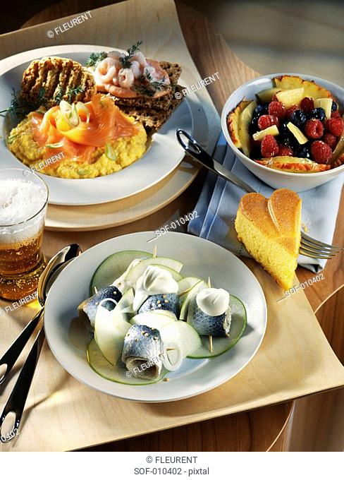 Rollmops with green apples, salmon scrambled eggs and fruit salad