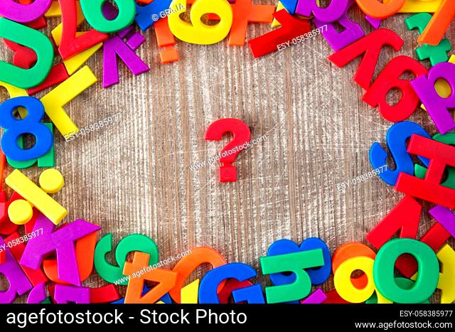 Border of colorful letters and numbers with question mark in a middle
