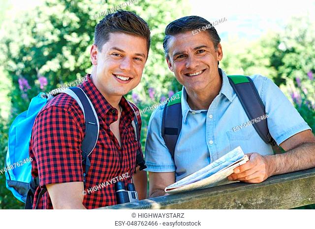 Father With Adult Son On Walk In Countryside Together