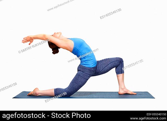 Beautiful sporty fit yogini woman practices yoga asana Anjaneyasana - low crescent lunge pose in surya namaskar in studio isolated on white