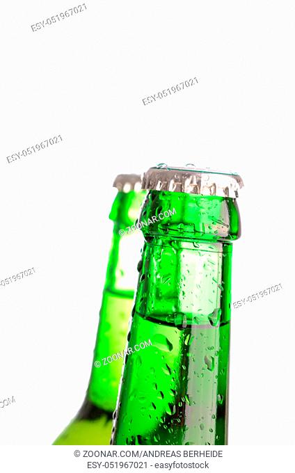 Two bottles of beer with drops of water on a white background