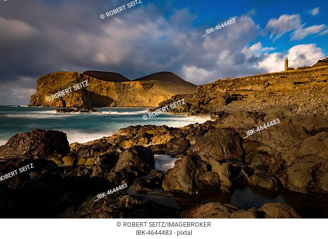 Rocky coast with lighthouse Farol da Ponta dos Capelinhos, Capelinhos peninsula, island of Faial, Azores, Portugal