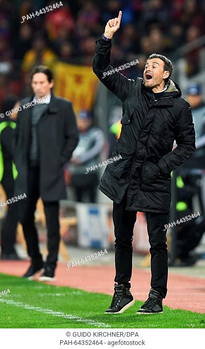 Barcelona's head coach Luis Enrique gestures at the sidelines, with his Leverkusen counterpart Roger Schmidt pictured in the background