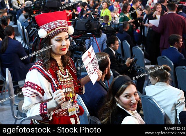 RUSSIA, MOSCOW - DECEMBER 14, 2023: A woman in a traditional costume carry a sign reading ""Mordovia"" ahead of an annual national live televised...