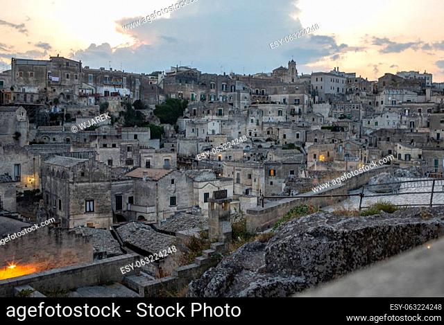 Evening view of the city of Matera; Italy; with the colorful lights highlighting old buildings in the Sassi di Matera a historic district in the city of Matera