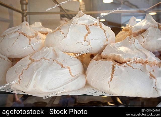 Portuguese suspiros pastries displayed on shop. Traditional dessert commonly known as meringues