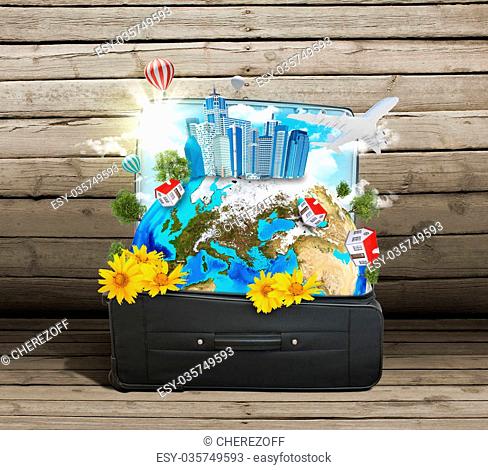 Earth with buildings, trees and travel bag on old wooden surface. Elements of this image are furnished by NASA
