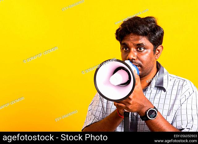Asian happy portrait young black woman standing to make announcement message shouting screaming in megaphone, studio shot isolated on yellow background with...