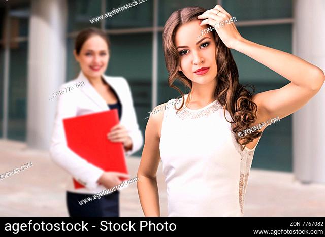 Young and beautiful business woman exploring documents in a red folder