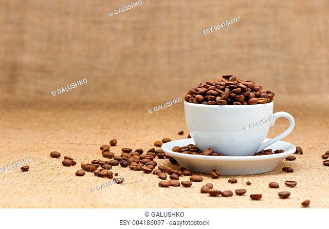 White cup with coffee grains
