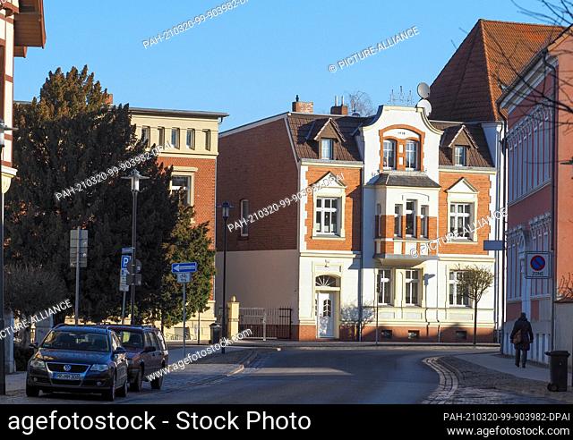 16 March 2021, Brandenburg, Perleberg: Residential and commercial buildings stand on Wittenberger Straße, which leads from the railway station towards the...