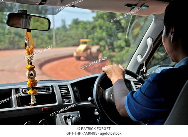 DRIVER AT THE WHEEL OF HIS CAR PROTECTED BY HIS GRIGRI IN THE KING’S COLORS, BANG SAPHAN, THAILAND, ASIA
