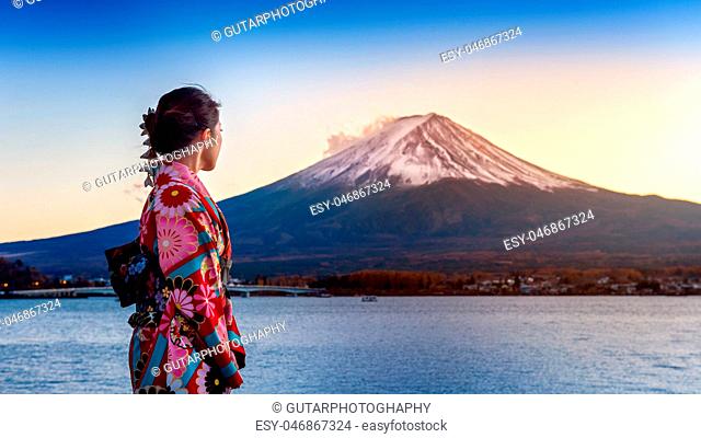 Asian woman wearing japanese traditional kimono at Fuji mountain. Sunset at Kawaguchiko lake in Japan