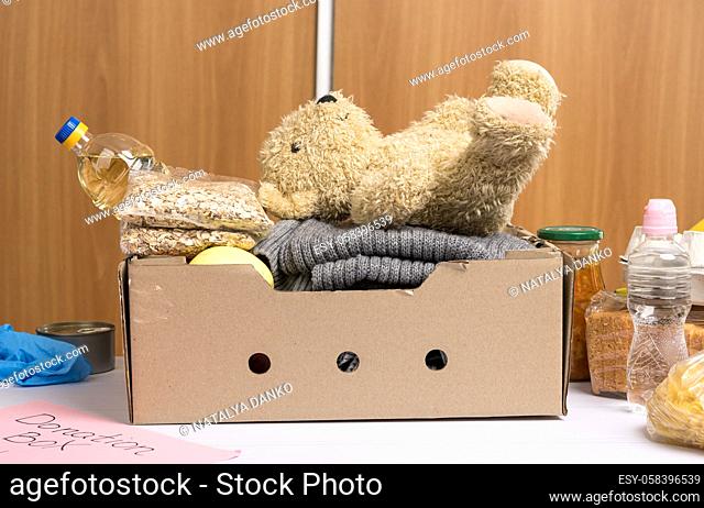 cardboard box with food and things to help those in need, concept of help and volunteering