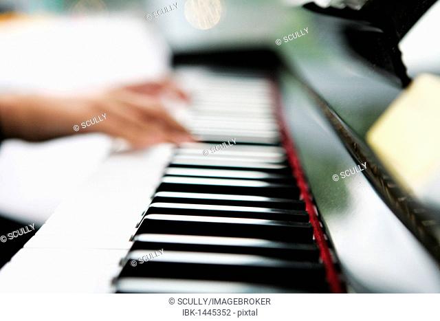 Hands on a piano keyboard