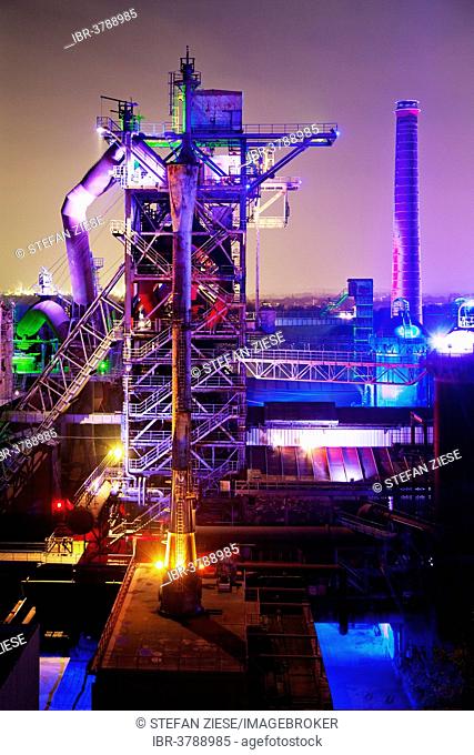 The disused steelworks in Landschaftspark Duisburg-Nord, public park on a former industrial site, illuminated at night with blast furnace No 2, Duisburg