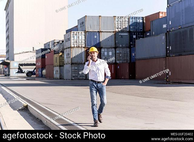 Businessman on the phone at industrial site