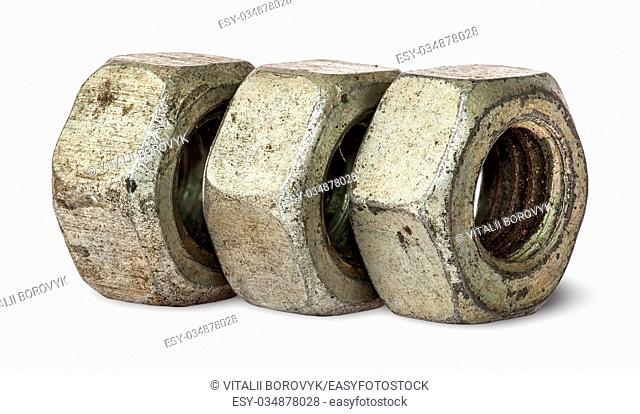 Three old rusty nuts in a row isolated on white background