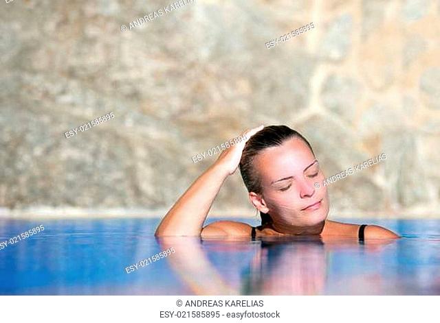 Young woman cools off in pool