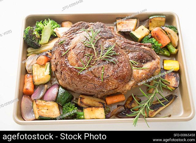 Beef steak with roasted vegetables on baking tray