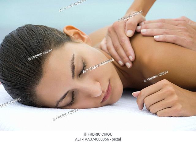 Young woman receiving back massage, cropped