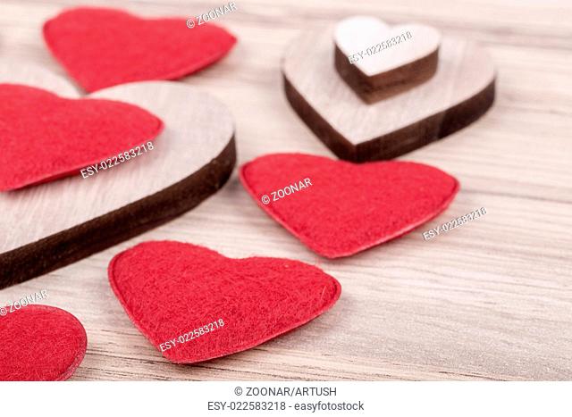 valentine's fabric and wooden hearts on a wooden background