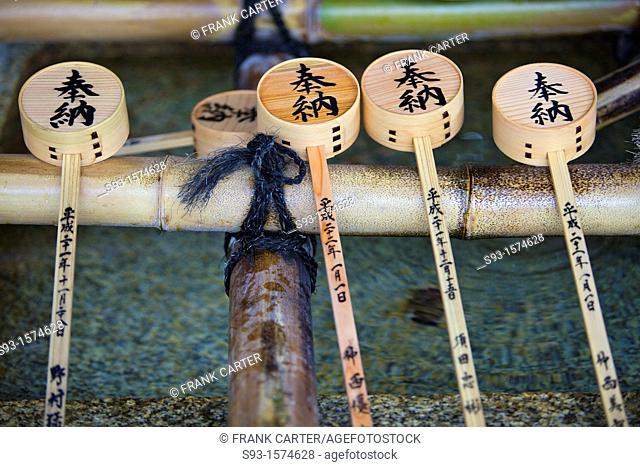Bamboo drinking ladles at a water basin at Yasaka Shrine
