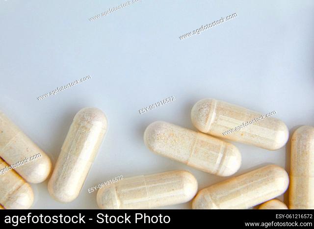 Flat lay macro White beige capsule pills, tablets, top view, close up texture background pharmaceutical industry concept, copy space