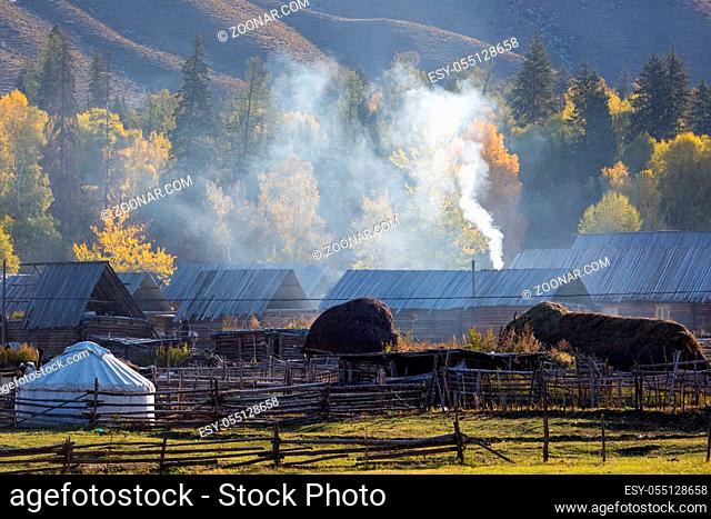 xinjiang baihaba villages in the morning, somke is spiralling upward from kitchens chimneys