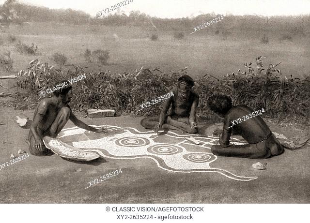 Members of the Warramunga tribe, Australia, preparing a ground drawing for a totemic ceremony. In this case the ceremony is connected with the black snake totem...