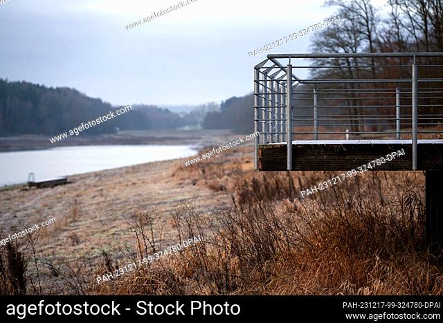 PRODUCTION - 15 December 2023, Bavaria, Stadtlauringen: A jetty stands on dry land. At the end of November 2021, all the water had to be drained from Lake...