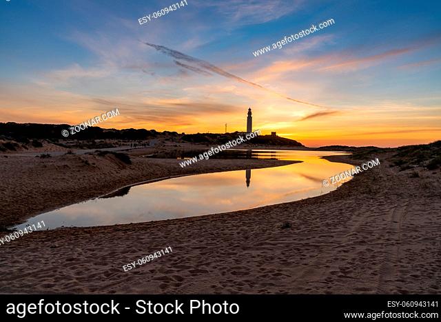 A view of the Cape Trafalgar lighthouse after sunset with colorful evening sky