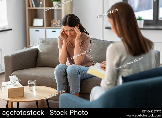 woman and psychologist at psychotherapy session