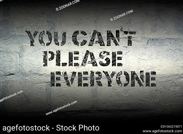 you can't please everyone stencil print on the grunge white brick wall