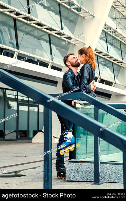 Beautiful roller skater couple with hipster style skating after the rain