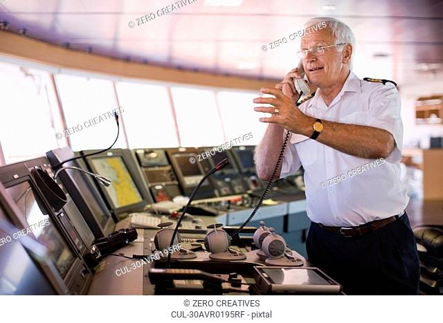 Captain of a ship having a phone call