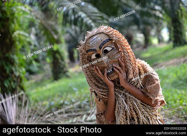 Carey Island, Selangor/Malaysia - Mar 17 2018: Malaysia aborigine Mah Meri with mask at oil palm estate,