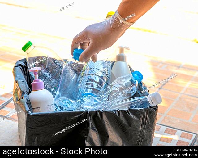 Woman holding plastic bottles garbage in box to reuse recycle for good environment