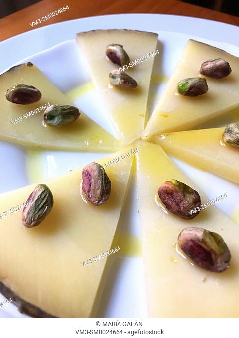 Manchego cheese with pistachios and olive oli. Spain