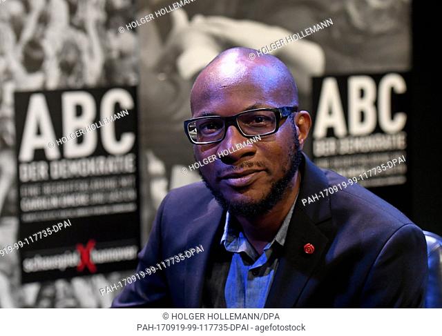 Photographer Teju Cole sits on stage at the start of the series 'ABC der Demokratie' (lit. ABC of democracy) in the Cumberlandsche Galerie in Hanover, Germany