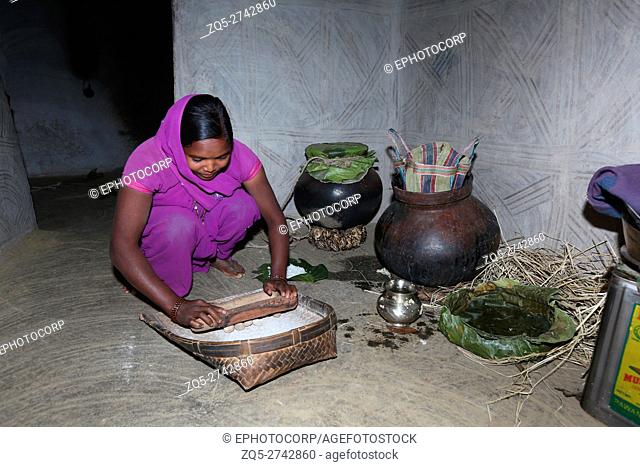 Girl making rice beer using Rani Goti mixture in Haddi, NAGESIA TRIBE, Lamgoan Village, Tahasil Lundra, District Sarguja, Chattisgarh, India
