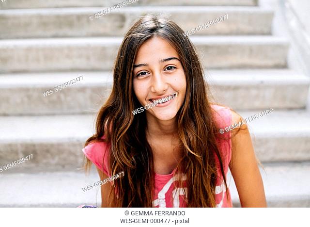 Portrait of happy girl at stairs