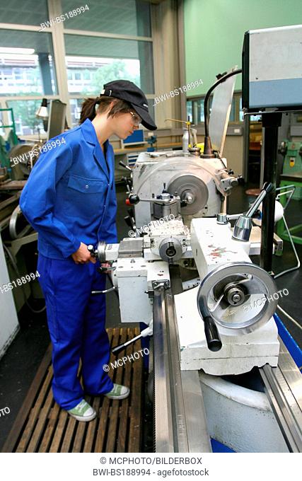 female apprentice working with machines