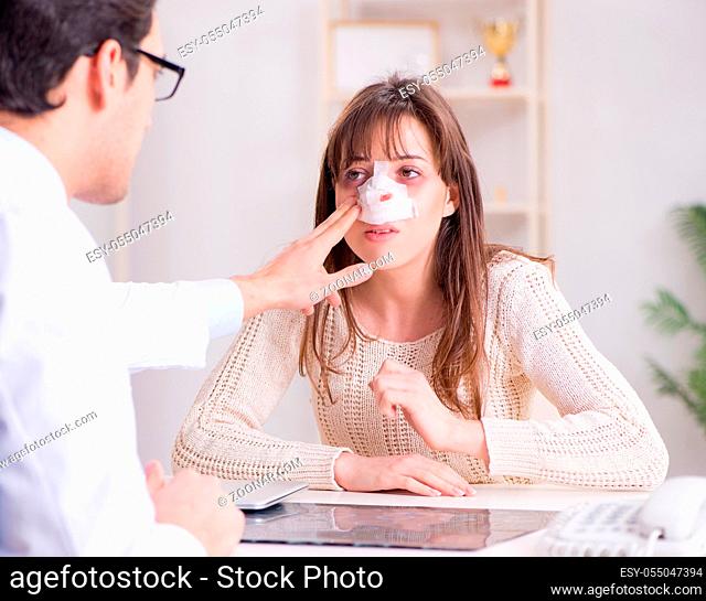 The male doctor talking to patient with nose operation surgery