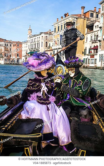 A masked couple in a gondola at the carnival in Venice, Italy, Europe