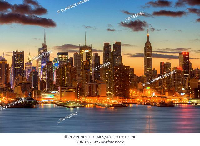 The Manhattan skyline in New York City during morning twilight as viewed over the Hudson River looking east from New Jersey